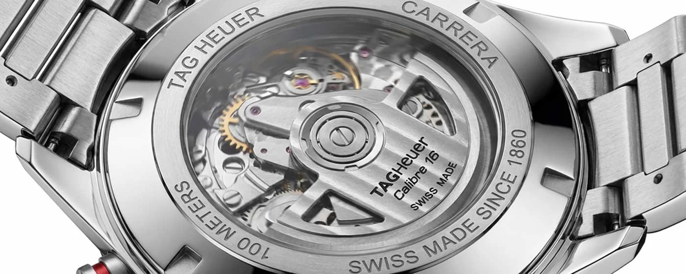 Close-up view through the exhibition caseback of the TAG Heuer Calibre 16 automatic movement showing the rotor with TAG Heuer branding and movement architecture